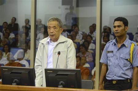 Former Khmer Rouge S-21 prison chief Kaing Guek Eav (L), also known as Duch, stands in a dock as he testifies at the Court Room of the Extraordinary Chambers in the Courts of Cambodia (ECCC) on the outskirts of Phnom Penh March 20, 2012. REUTERS/Nhet Sokheng/ECCC/Handout
