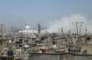 Smoke rises after what activists said was shelling by forces loyal to Syria's President Bashar al-Assad in central Homs