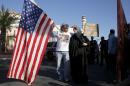 Two demonstrators stand in front of Islamic Community Center to oppose "Freedom of Speech Rally Round II" across street in Phoenix, Arizona