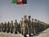 An Afghan police officer holds a national flag during a graduation ceremony in Herat, Afghanistan Wednesday, Aug 24, 2011. Over 200 Afghan police men graduated after getting 8 weeks of training by NATO and Afghan trainers in Herat. (AP Photo/Hoshan Hashimi)