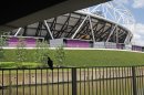 In this photo taken Wednesday June, 20, 2012, a bird sits on a railing overlooking the waterways, that were once polluted, at the bottom of the Olympic stadium, at the Olympic Park in London. After Sunday's closing ceremony it is hoped that once the massive crowds go home, bats will find themselves taking up residence in little bat boxes around the park, part of a lasting environmental legacy for east London's Olympic Park. (AP Photo/Elizabeth Dalziel)