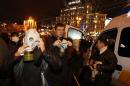 Protesters wear gas masks during a meeting to support EU integration at European square in Kiev