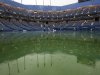 Water gathers on the court at Arthur Ashe Stadium during the U.S. Open tennis tournament in New York, Tuesday, Sept. 6, 2011. The start of play at the U.S. Open is being delayed because of rain. (AP Photo/Mel Evans)