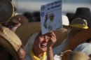 Pilgrims cheer and sing as they wait at the site where Pope Benedict XVI will give a Mass in Bicentennial Park near Silao, Mexico, Sunday March 25, 2012. (AP Photo/Dario Lopez-Mills)