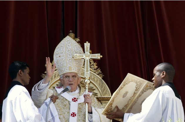 Pope Benedict XVI blesses the crowd as he makes his "Urbi et Orbi" address from a balcony in St. Peter's Square in Vatican