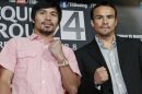 Manny Pacquiao, left, of the Philippines, and Juan Manuel Marquez, of Mexico, promote their upcoming boxing match during a news conference in Beverly Hills, Calif., Monday, Sept. 17, 2012. The two will fight for the fourth time on Dec. 8 in Las Vegas. (AP Photo/Reed Saxon)
