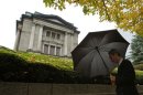 A man walks past the Bank of Japan headquarters in Tokyo