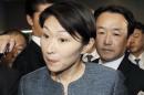 Japan's Economy, Trade and Industry Minister Obuchi is surrounded by reporters as she speaks in Tokyo