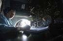 Senior Lieutenant Phung Truong Son takes notes while working within the cockpit of a Vietnam Air Force AN-26 aircraft during a mission to find the missing Malaysia Airlines flight MH370, off Con Dao island