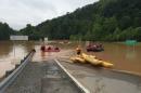 Emergency crews take out boats on a flooded I-79 at the Clendenin Exit in Kanawha County