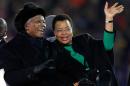 FILE - In this July 11, 2010 file photo, former South African President Nelson Mandela, left, sits next to his wife, Graca Machel, as they are driven across the field ahead of the World Cup final soccer match between the Netherlands and Spain at Soccer City in Johannesburg, South Africa. South Africa's president Jacob Zuma says, Thursday, Dec. 5, 2013, that Mandela has died. He was 95. (AP Photo/Luca Bruno, File)