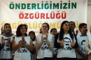 People wearing T-shirts featuring jailed PKK leader Abdullah Ocalan applaud during a speech by Turkey's pro-Kurdish People's Democratic Party co-chair Sebahat Tuncel speech on September 5, 2016 in Diyarbakir before starting a hunger strike
