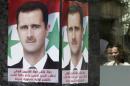 Posters of Syrian President Assad placed by pro-Assad group "Qasion Forum", calling for him to run for a third term, are seen at a street in Damascus