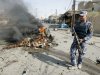 A policeman stands guard at the site of a bomb attack in Kirkuk