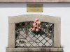 In this photo taken Friday, Aug. 3, 2012, the municipality of Monza commemorates Lea Garofalo with flowers and a plaque as an example of courage as a witness for legality, at a cemetery wall near the spot where she was murdered in Monza, near Milan, Italy. Grofalo, a woman who dared to cooperate with police in the fight against a dreaded Italian mob network was murdered, her body dumped in a barrel of acid in the countryside near Milan. Her 17-year-old daughter stepped forward and testified, helping to send six people to prison for life. (AP Photo/Antonio Calanni)