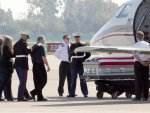 Accompanied by a U.S. Marines, the family of Marine Cpl. Christopher G. Singer approaches his casket upon its return to Southern California in what is called a Hero Mission ceremony at the Joint ...