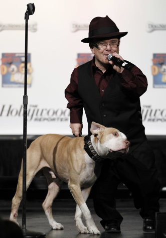 Shorty Rossi, left, and Hercules, from the television show "Pit Boss", accept the award for Best Dog in a Reality Television Series at the first annual Golden Collar Awards in Los Angeles, Monday, Feb. 13, 2012. The Golden Collar awards recognize the work of dogs in film and television. (AP Photo/Matt Sayles)