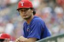 FILE - In this Sunday, Aug. 30, 2015 file photo,Texas Rangers pitcher Yu Darvish of Japan watches from the dugout during a baseball game against the Baltimore Orioles in Arlington, Texas. Yu Darvish says he has never been involved in gambling activities, but otherwise isn't commenting on a Major League Baseball investigation after the arrest of his younger brother in Japan. Darvish issued a statement Tuesday, Jan. 19, 2016 through his agent that says he understands MLB must conduct an investigation. But the Texas Rangers pitcher says he's certain they will find he had no involvement whatsoever. (AP Photo/LM Otero, File)