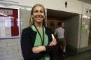 In this photo taken May 13, 2016, Lincoln High School principal Peyton Chapman poses for a photo in the halls of the school in Portland, Ore., Friday, May 13, 2016. Chapman recalls the 