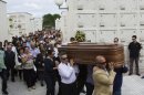 People carry a coffin of a medical student, Laura Naveiras Ferreiro, one of the train crash victim, during her funeral at the San Pedro de Visma cementery in A Coruna, Spain, Saturday, July 27, 2013. Spain's interior minister Jorge Fernandez Diaz says the driver whose speeding train crashed, killing 78 people, is now being held on suspicion of negligent homicide. The Spanish train derailed at high speed Wednesday killing 78 and injuring dozens more. (AP Photo/Lalo R. Villar)