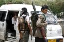 Fighters of the Popular Resistance Committees man a checkpoint in Taiz