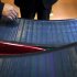 Company executives look at thin-film solar panels developed by MiaSole before a press conference held at the headquarters of Hanergy Group in Beijing, China, Wednesday, Jan. 9, 2013. Hanergy Group, the Chinese company that bought MiaSole, a California producer of thin-film solar panels, said it can make a success of the emerging technology where others have suffered huge losses. (AP Photo/Alexander F. Yuan)