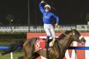 Monterosso from Great Britain ridden by Mickael Barzalona, crosses the finish line to win the Dubai World Cup race, Saturday, March 31, 2012, in Dubai, United Arab Emirates. (AP Photo/Stephen Hindley)