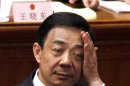 In this photo taken Friday, March 9, 2012, Chongqing party secretary Bo Xilai rubs his face during a session of the National People's Congress held in Beijing. China's state news agency announced Thursday, March 15, 2012 that Bo resigned amid a scandal involving his former police chief and replaced by Chinese Vice Premier Zhang Dejiang. (AP Photo/Ng Han Guan)