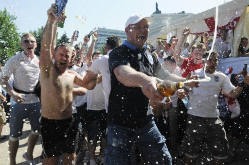 English soccer fans spray beer before the group D match between England and France during the Euro 2012 soccer championship in Donetsk, Ukraine, Ukraine, Monday, June 11, 2012. (AP Photo/Sergei Chuzavkov)