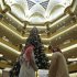 Visitors look at the $11 million Christmas tree in the lobby of the Emirates Palace in Abu Dhabi