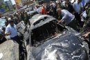 Syrians gather at the scene of two huge bomb explosions outside the Palace of Justice in Damascus