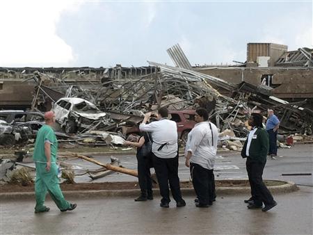 People look at the destruction after a huge tornado struck Moore, Oklahoma May 20, 2013. REUTERS/Gene Blevins
