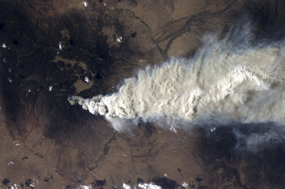 This image provided by NASA shows an image taken by a crew member aboard the International Space Station, flying at an altitude of approximately 235 statute miles on Monday June 27, 2011, exposed this still photograph of a major fire in the Jemez Mountains of the Santa Fe National Forest in north-central New Mexico. The fire is just southwest of Los Alamos National Laboratories. (AP Photo/NASA)