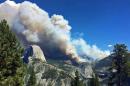 In this photo provided by Yosemite National Park, smoke from a fire rises above Little Yosemite Valley near Yosemite National Park, Calif., Sunday, Sept. 7, 2014. About 100 Yosemite National Park visitors were evacuated by helicopter Sunday when a wildfire that started weeks ago in the park's backcountry grew unexpectedly to at least 700 acres, officials said. (AP Photo/Yosemite National Park)