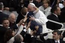Pope Francis hugs a child after celebrating his first Easter Mass in St. Peter's Square at the Vatican, Sunday, March 31, 2013. Pope Francis celebrated his first Easter Sunday Mass as pontiff in St. Peter's Square, packed by joyous pilgrims, tourists and Romans and bedecked by spring flowers.Wearing cream-colored vestments, Francis strode onto the esplanade in front of St. Peter's Basilica and took his place at an altar set up under a white canopy. (AP Photo/Gregorio Borgia)