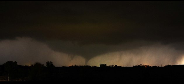 A tornado on the ground makes it way through the night near Salin