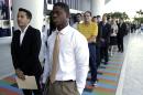 FILE - In this Wednesday, Oct. 23, 2013, file photo, Luis Mendez, 23, left, and Maurice Mike, 23, wait in line at a job fair held by the Miami Marlins, at Marlins Park in Miami. Employers added a scant 74,000 jobs in December after averaging 214,000 in the previous four months. The Labor Department said Friday, Jan. 10, 2014, that the unemployment rate fell from 7 percent in November to 6.7 percent, its lowest level since October 2008. But the drop occurred mostly because many Americans stopped looking for jobs. Once people without jobs stop looking for one, the government no longer counts them as unemployed. (AP Photo/Lynne Sladky, File)