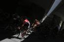 The pack passes through a tunnel during the twentieth stage of the Tour de France cycling race over 110.5 kilometers (68.7 miles) with start in Modane and finish in Alpe d'Huez, France, Saturday, July 25, 2015. (AP Photo/Laurent Cipriani)