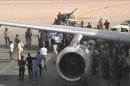 Still image taken from video shows airport officials negotiating with members of al-Awfea militia on the tarmac of Tripoli international airport