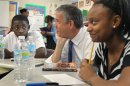 FILE - In this Monday, June 25, 2012 file photo, during a fact-finding tour of Vashon High School, U.S. Secretary of Education Arne Duncan, center, listens to eighth-grade students Delvion Mitchell, 14, and Makayla Lewis, 14, as they discuss social issues they have encountered at school and what they have learned from them, in St. Louis. Five more states have been granted relief from key requirements of the Bush-era No Child Left Behind law, bringing the total to 24 states given waivers, the Education Department said Friday, June 29, 2012. Arkansas, Missouri, South Dakota, Utah and Virginia will be freed from the No Child Left Behind requirement that all students test proficient in math and science by 2014, a goal the nation remains far from achieving. (AP Photo/St. Louis Post-Dispatch, J.B. Forbes, File) EDWARDSVILLE INTELLIGENCER OUT; THE ALTON TELEGRAPH OUT