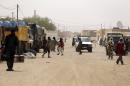People walk in the market district on July 27, 2013 in the northern Malian city of Kidal