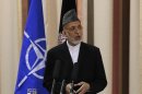 Afghan President Karzai speaks during joint news conference with NATO Secretary General Rasmussen following security handover ceremony at a military academy outside Kabul