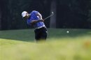 Tiger Woods plays his second shot on the 14th hole during the AT&T National golf tournament in Bethesda