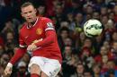 Manchester United's English striker Wayne Rooney takes a free kick during the pre-season football friendly match between Manchester United and Valencia at Old Trafford on August 12, 2014