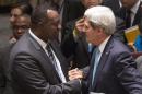 Rwanda Ambassador to the United Nations Eugene-Richard Gasana greets U.S. Secretary of State John Kerry after taking part in a United Nations Security Council meeting in New York