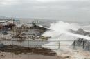Waves crash onto the shore at a fishing harbour in Visakhapatnam district