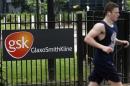 A jogger runs past a signage for pharmaceutical giant GlaxoSmithKline in London