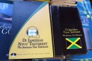 In this Dec. 3, 2012 photo, the covers of two editions of the new Jamaican patois translation of the New Testament are shown at the office of the Bible Society of the West Indies in Kingston, Jamaica. After years of translation from the original Greek, the Bible Society is releasing in Jamaica print and audio CD versions of the first patois translation of the New Testament, or "Di Jamiekan Nyuu Testiment." The language was created by slaves who were brought to the island by European colonizers, and some say it was designed to prevent slave masters from understanding their words. (AP Photo/David McFadden)
