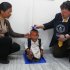 Editor in Chief of Guinness World Records Craig Glanday, right, and Dr. Kashila Pradhan, left, officially measure Nepal's Chandra Bahadur Dangi, 72, who says he's only 22 inches (56 centimeters) tall, at the CIWEC clinic in Katmandu, Nepal, Sunday, Feb. 26, 2012. Guinness World Records officials measured Dangi who hopes to be named the world's shortest man later Sunday. Dangi is hoping to snatch the title of the world's shortest man from Junrey Balawing of the Philippines, who is 23.5 inches (60 centimeters) tall. (AP Photo/Niranjan Shrestha)