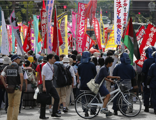 Anti-nuclear protesters stage a rally in Hiroshima, western Japan, Monday, Aug. 6, 2012. Hiroshima marked the 67th anniversary of the atomic bombing Monday. A banner, third right, reads